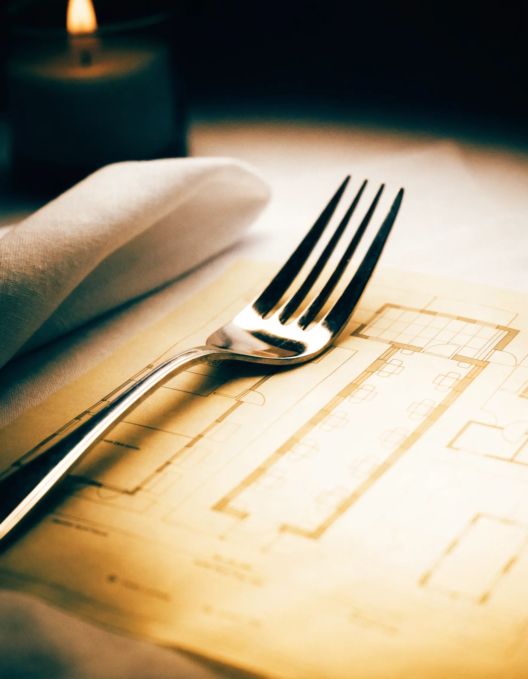 A blueprint resting on white table linen