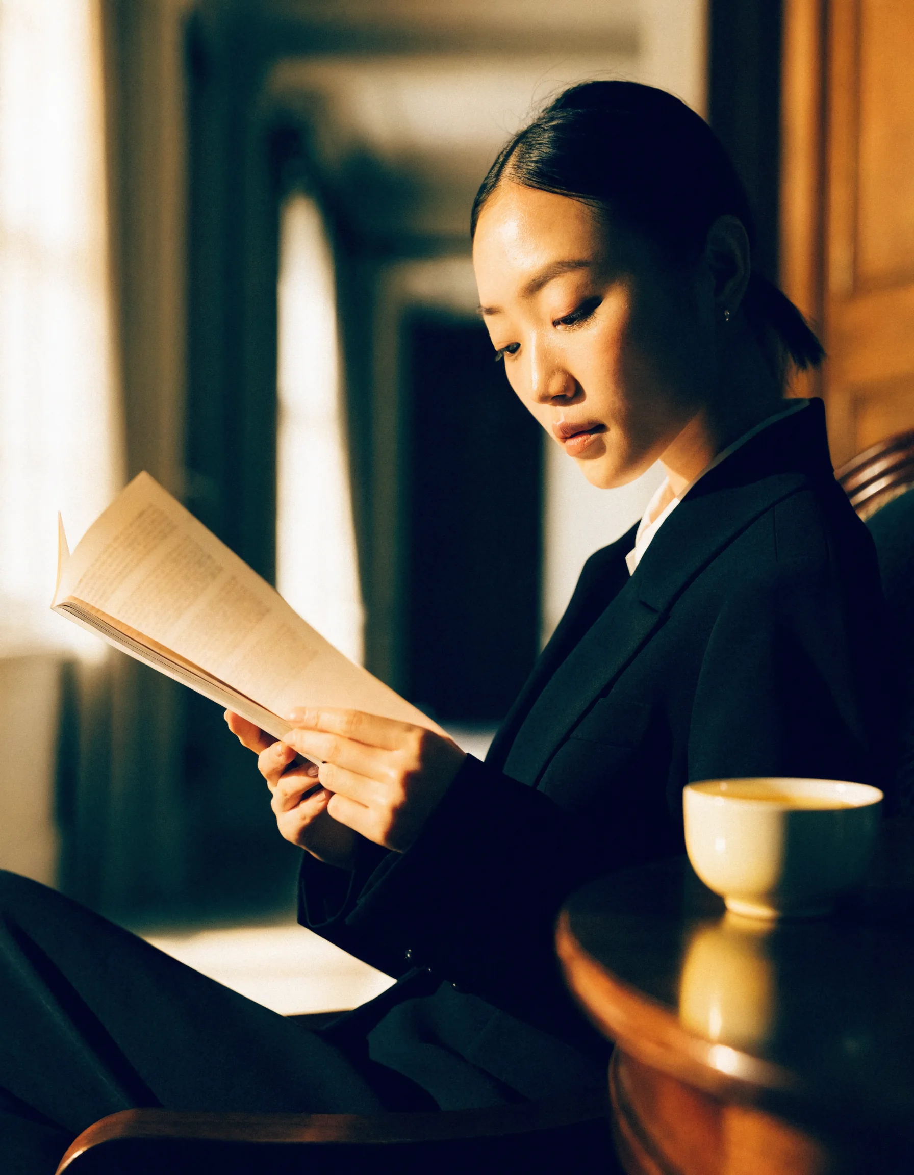 A calm woman reading a bound report